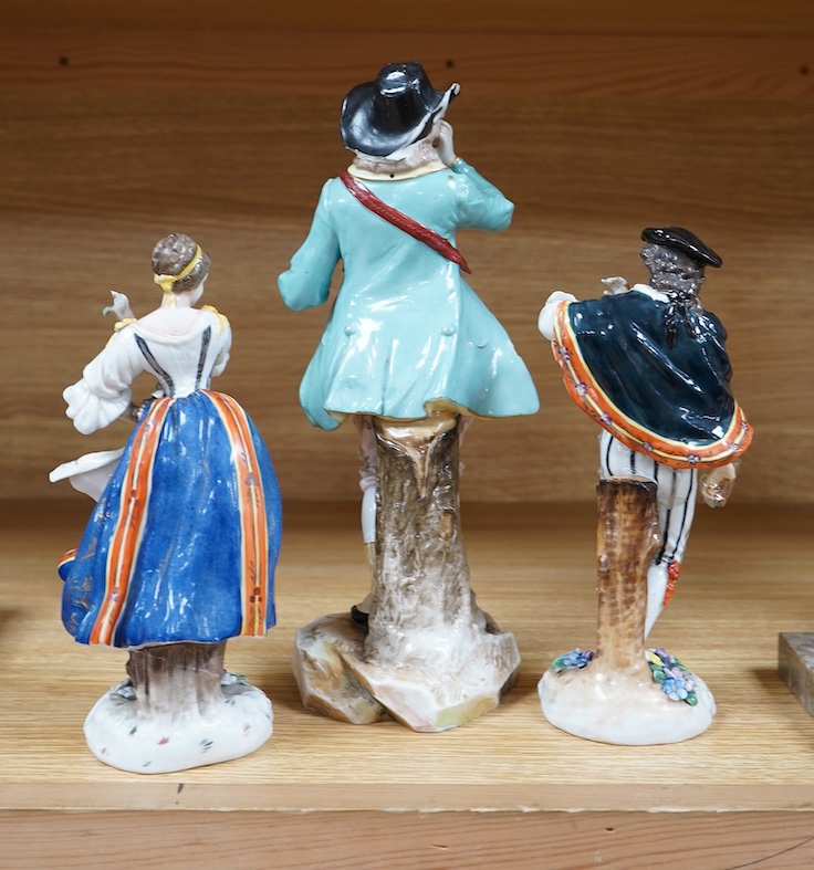 A Ludwigsburg porcelain figure and a pair of Berlin figures, tallest 27cm. Condition - poor